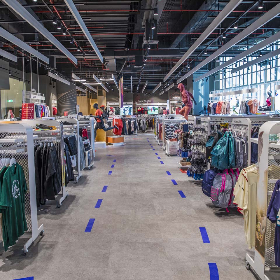 Intersport sponsored cleanup station with volunteers organizing collected waste