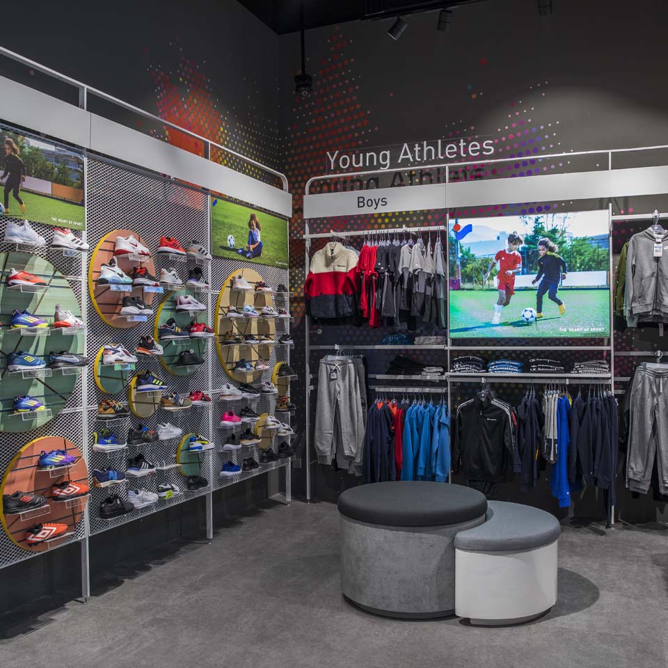 Volunteers in purple shirts carrying large bags of collected desert waste