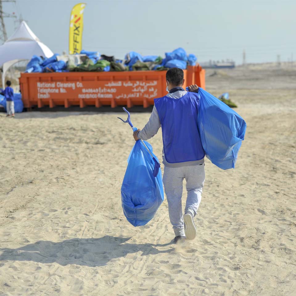 Team of volunteers working together to clean up desert area