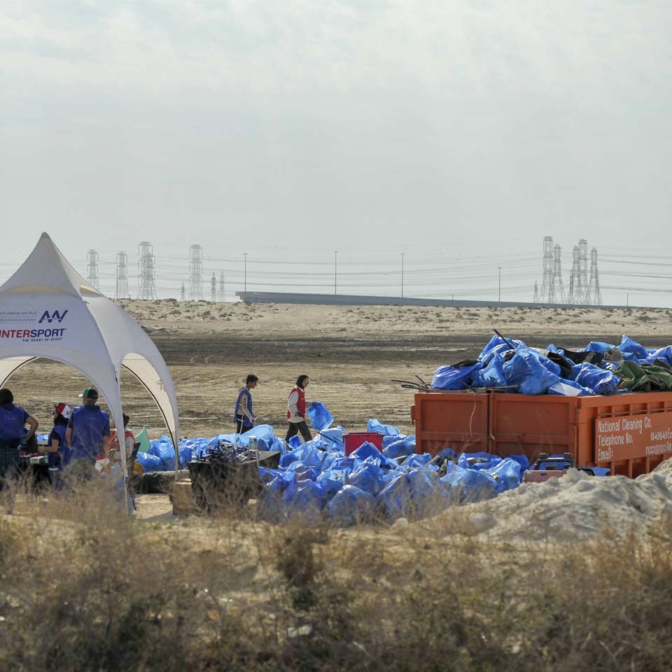 Team of volunteers working together to clean up desert area