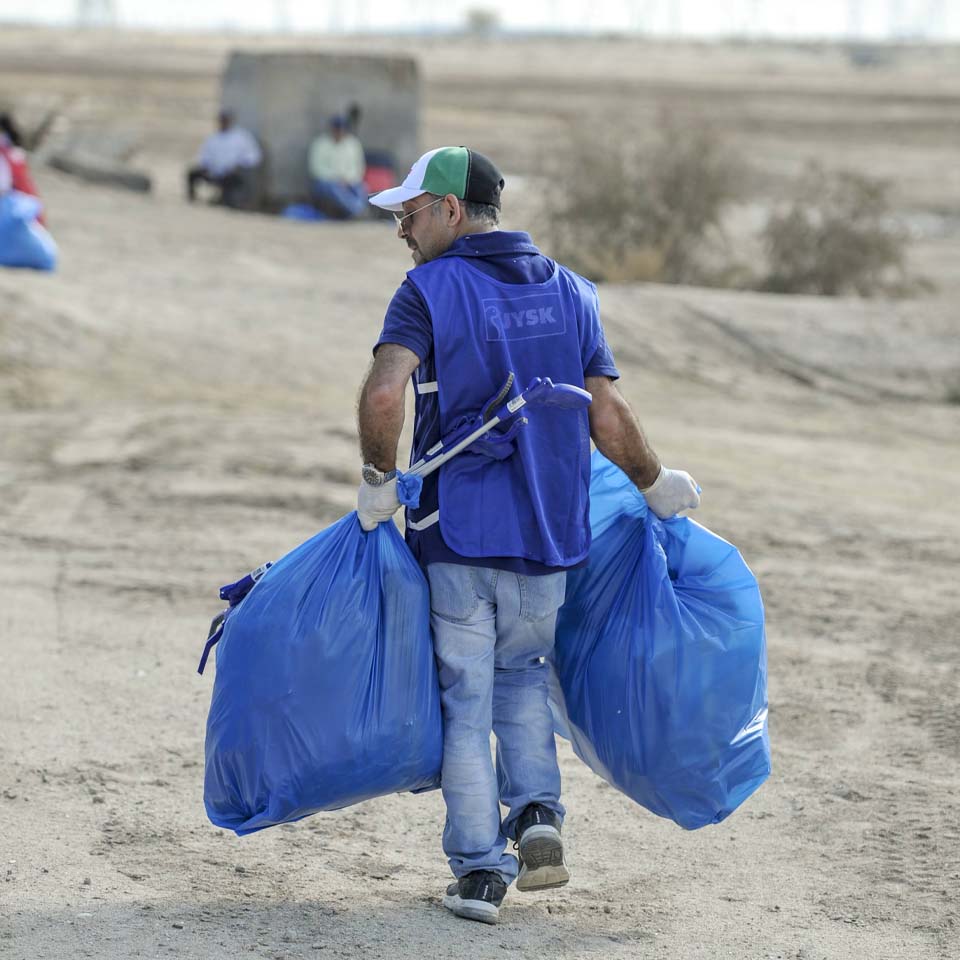 Team of volunteers working together to clean up desert area