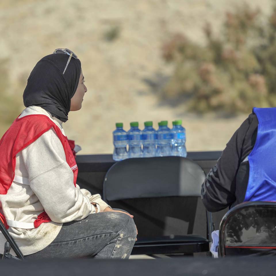 Intersport sponsored cleanup station with volunteers organizing collected waste