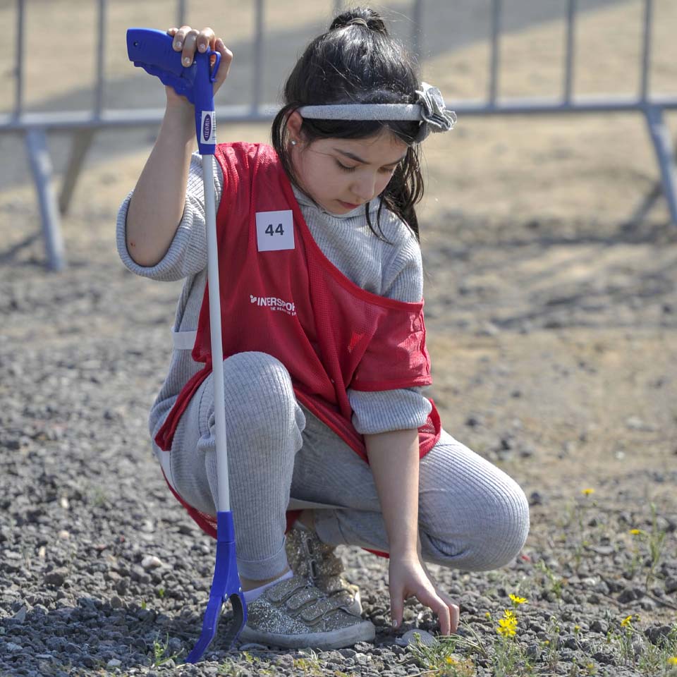 Team of volunteers working together to clean up desert area