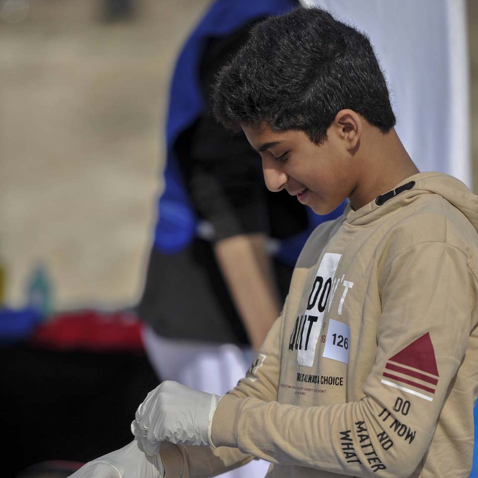 Team of volunteers working together to clean up desert area