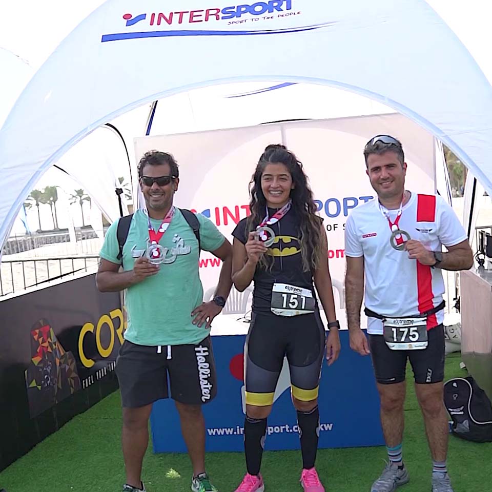 Desert cleanup volunteers in purple shirts walking across desert terrain