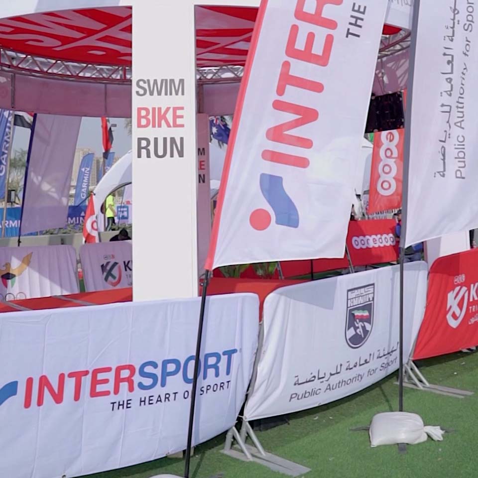 Intersport sponsored cleanup station with volunteers organizing collected waste