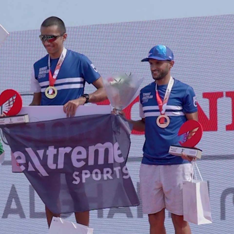 Desert landscape with cleanup volunteers and collection points visible in distance