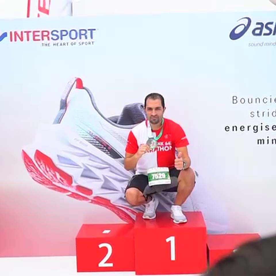 Desert landscape with cleanup volunteers and collection points visible in distance