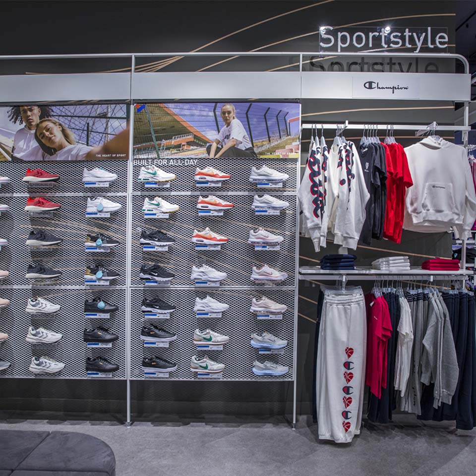 Volunteers in purple shirts carrying large bags of collected desert waste